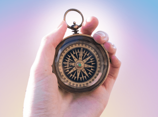 Hand-holding-a-compass hand holding a compass